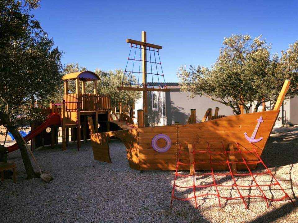 Children's playground with wooden play boat at the property